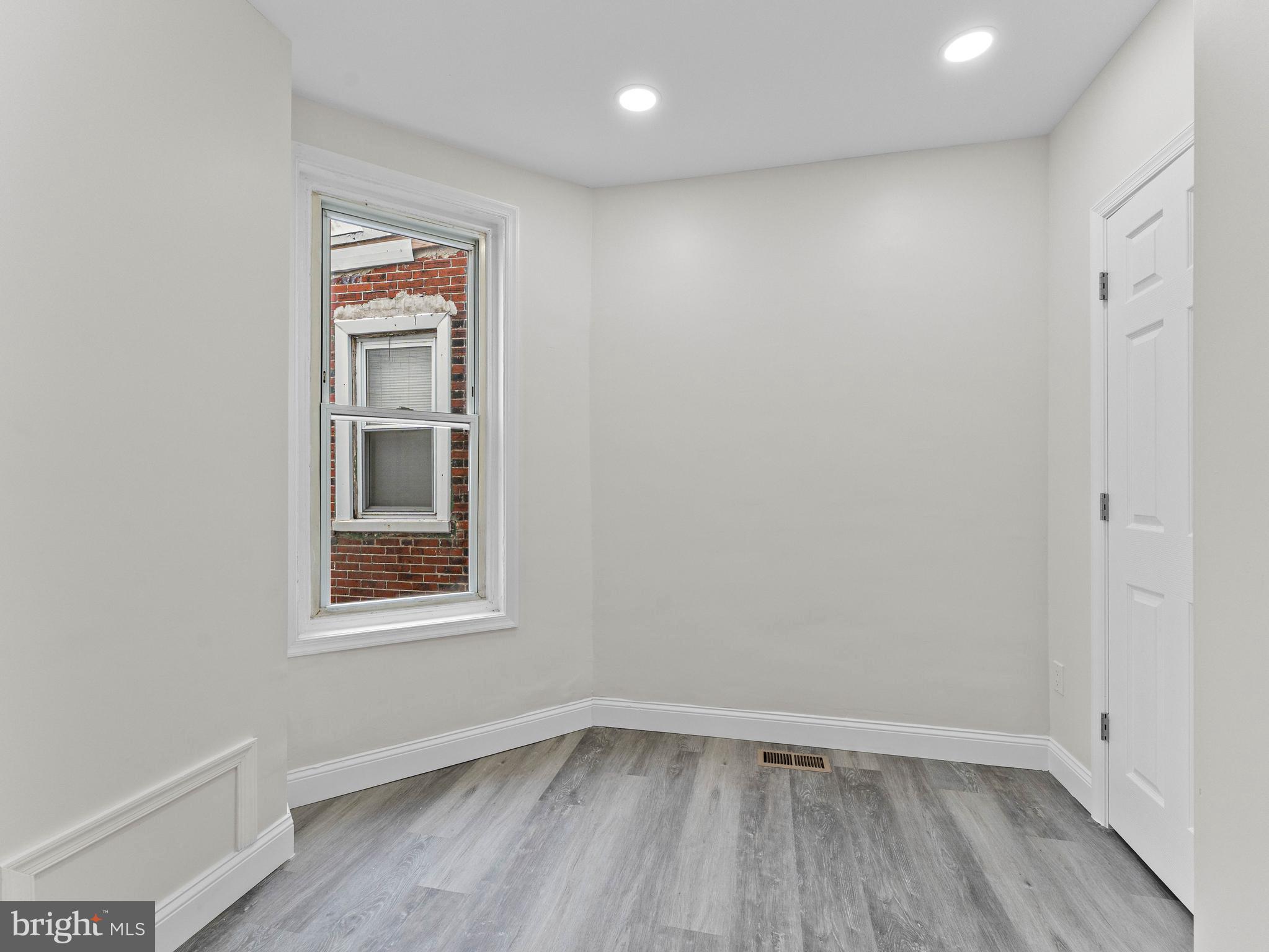 5422 Regent Street Philadelphia, PA 19143 - Photo 20 of 35 a view of an empty room with wooden floor and a window