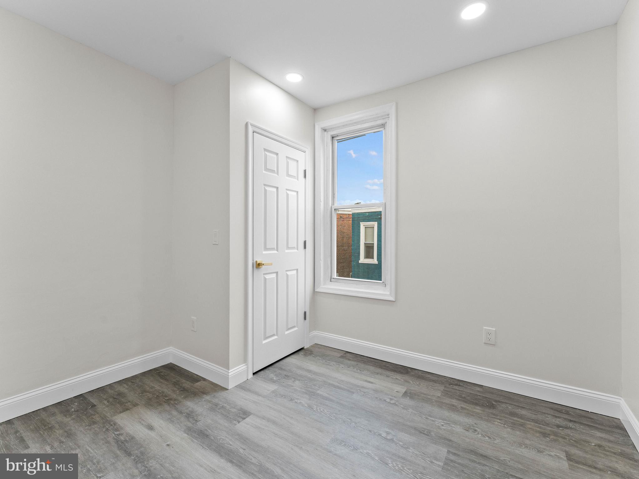 5422 Regent Street Philadelphia, PA 19143 - Photo 24 of 35 an empty room with wooden floor and windows