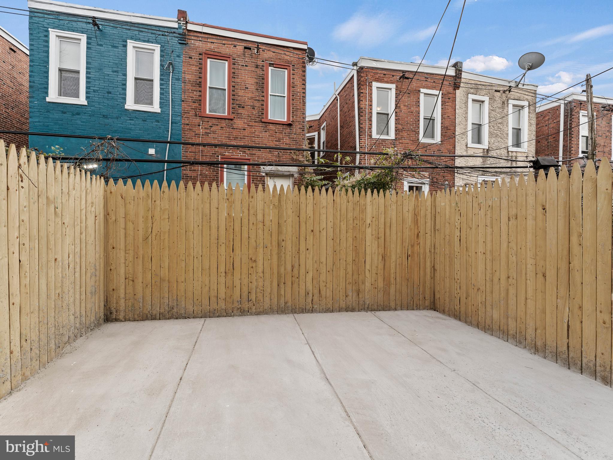 5422 Regent Street Philadelphia, PA 19143 - Photo 34 of 35 a view of a brick house with a wooden fence