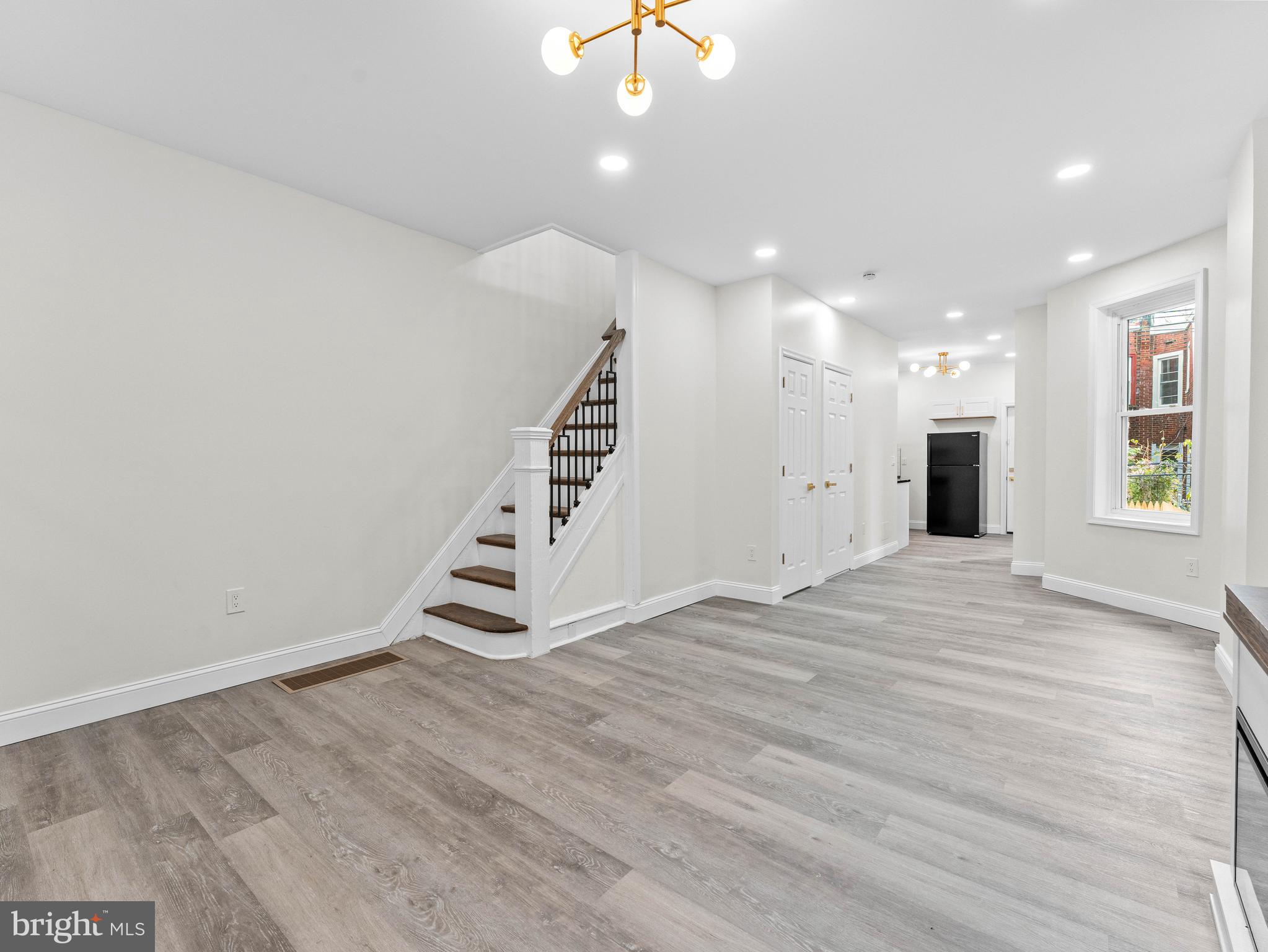 5422 Regent Street Philadelphia, PA 19143 - Photo 6 of 35 an empty room with wooden floor and entryway