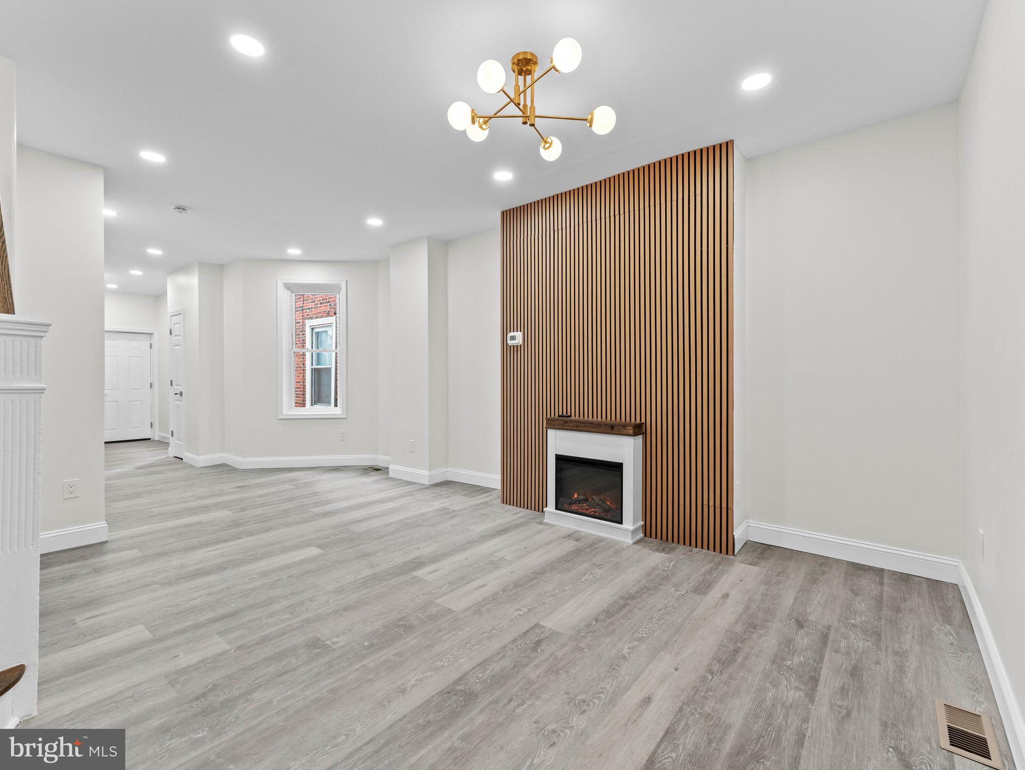 5422 Regent Street Philadelphia, PA 19143 - Photo 8 of 35 a view of an empty room with a fireplace and a window