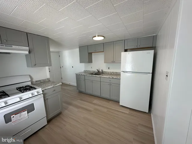 a kitchen with a white cabinets and white appliances