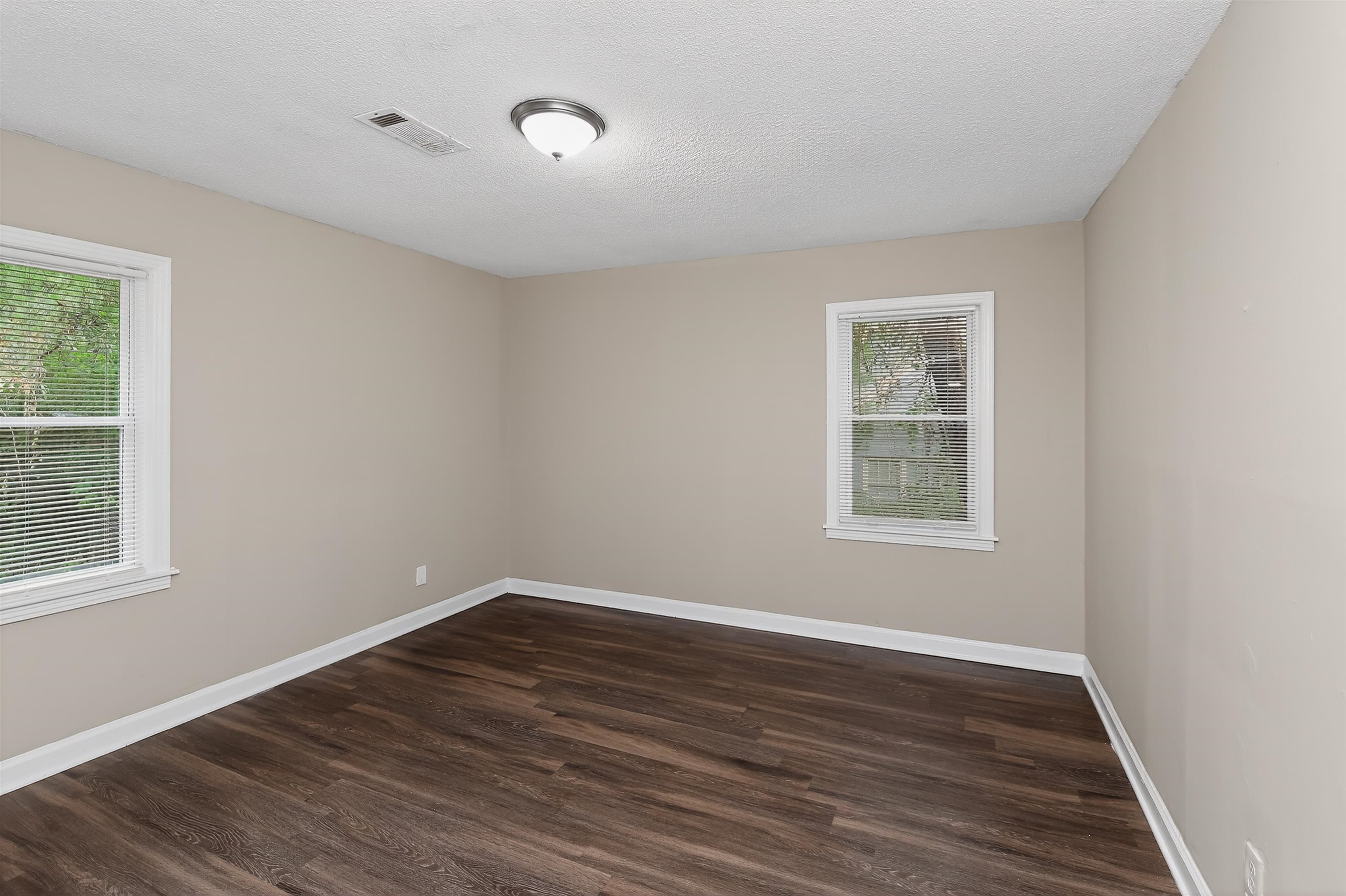 318 East Raines Road Memphis, TN 38109 - Photo 17 of 28 Neutral-toned walls complement wood-finish flooring in this room