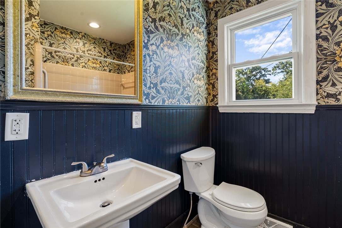 419 Whitehall Road Anderson, SC 29625 - Photo 16 of 28 Bold patterned wallpaper and classic wainscoting define this charming bathroom, offering a serene escape.
