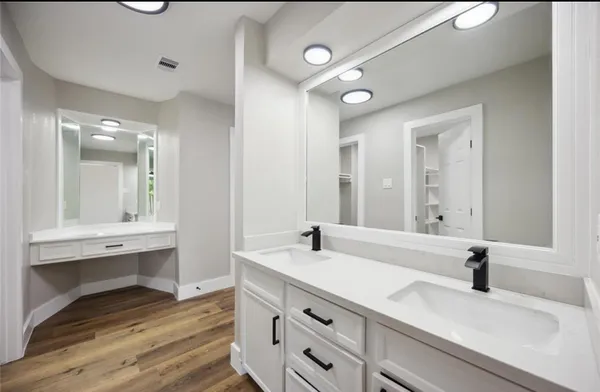 a bathroom with a tub sink and mirror