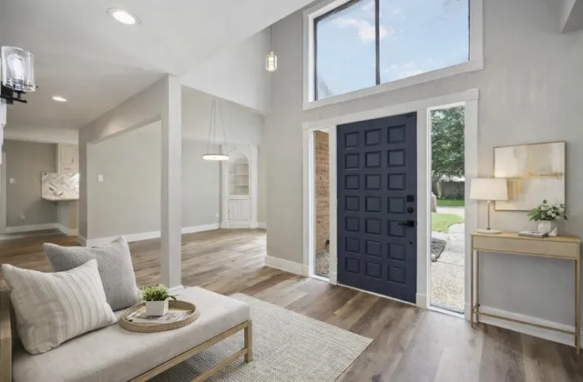 a living room with furniture and wooden floor