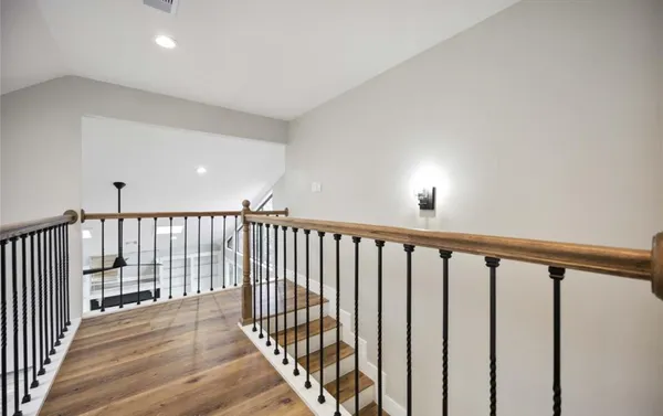 a view of a hallway with wooden floor