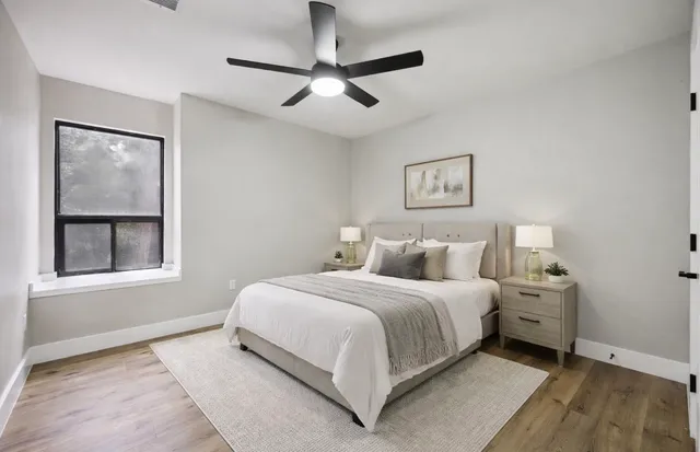 a bedroom with a large bed and a window