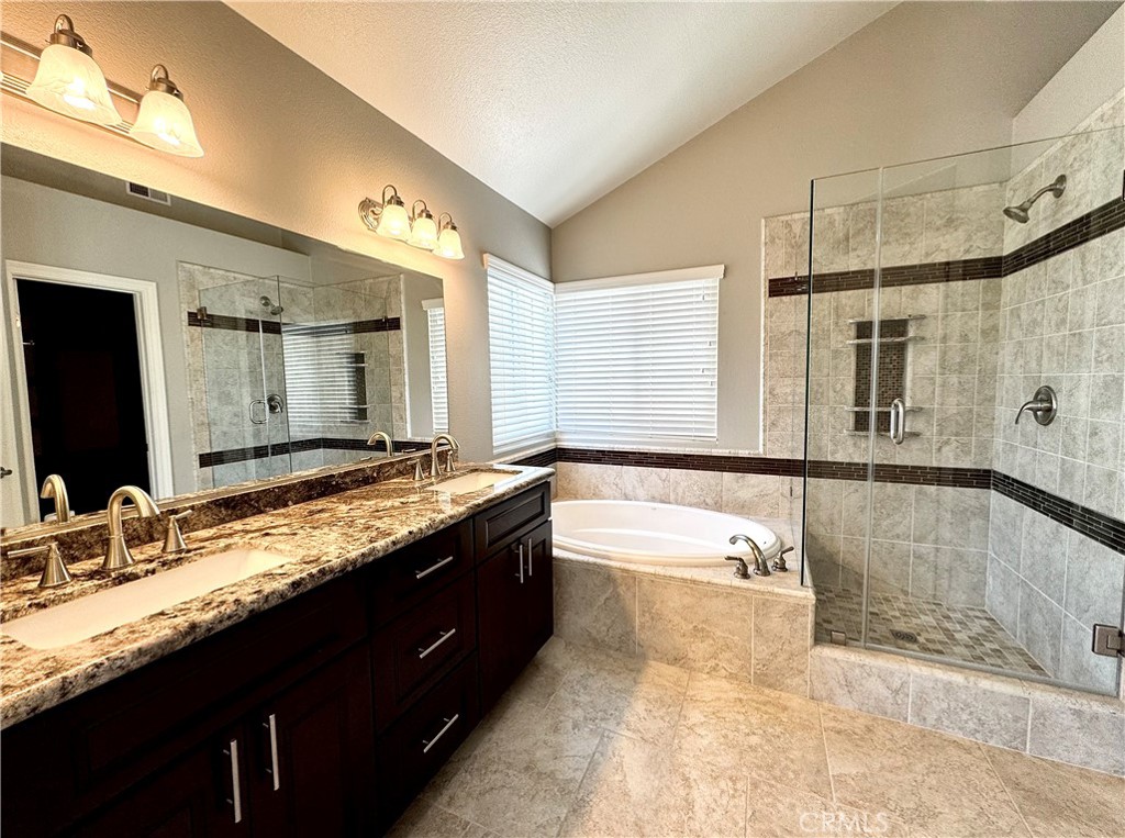 16073 Crestline Drive La Mirada, CA 90638 - Photo 25 of 75 a bathroom with a granite countertop double vanity sink and a bathtub