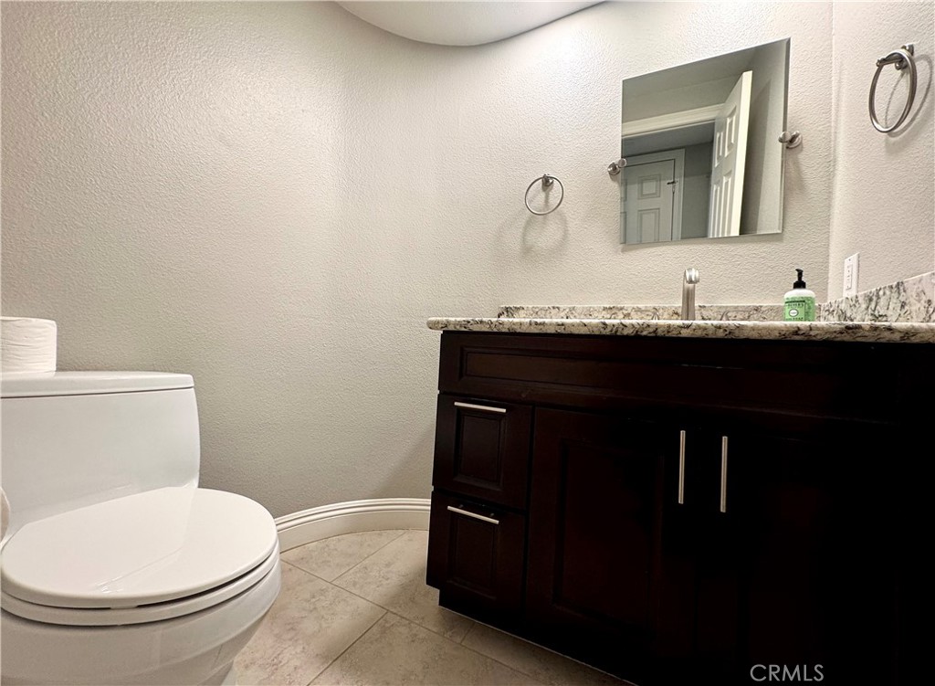 16073 Crestline Drive La Mirada, CA 90638 - Photo 29 of 75 a bathroom with a granite countertop toilet sink and mirror