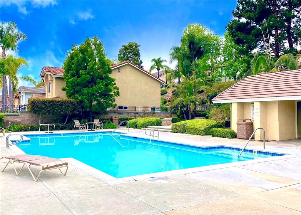 16073 Crestline Drive La Mirada, CA 90638 - Photo 46 of 75 a view of a house with a swimming pool and a yard