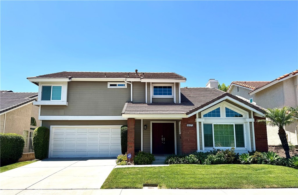 16073 Crestline Drive La Mirada, CA 90638 - Photo 75 of 75 a front view of a house with a yard and garage
