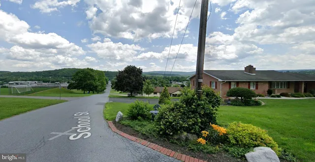 a view of a garden with a table and chairs under an umbrella