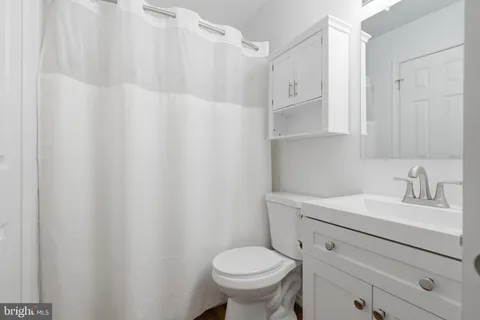 a bathroom with a sink toilet and a mirror