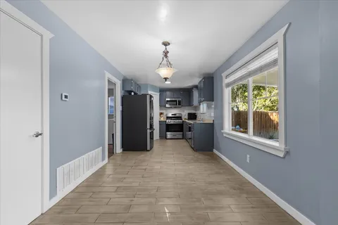 a large kitchen with a stove and refrigerator