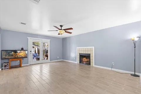 a view of a livingroom with furniture ceiling fan and fireplace