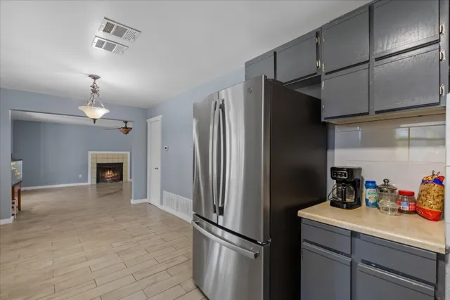 a kitchen with cabinets and stainless steel appliances
