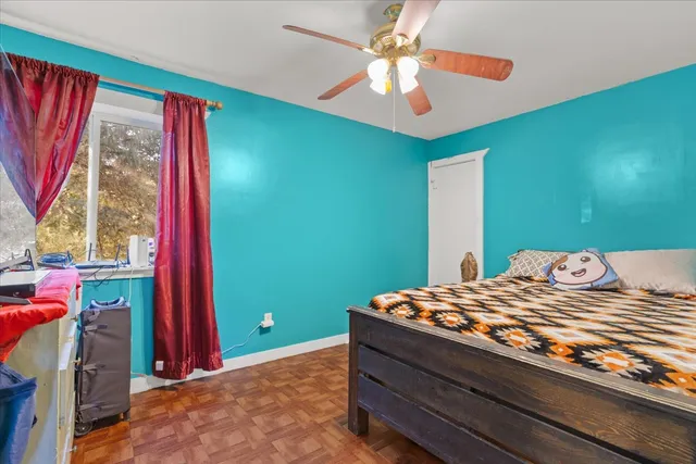 a bedroom with a bed and a chandelier