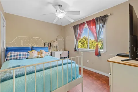 a bedroom with furniture and a window