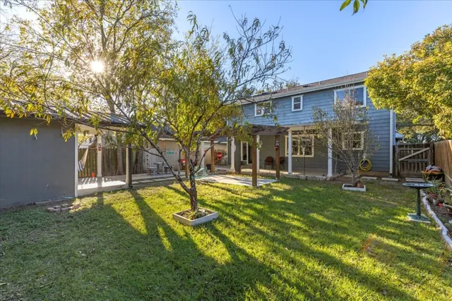 a view of a house with a yard patio and swimming pool