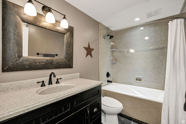 288 525 South Providence, UT 84332 - Photo 32 of 71 Vanity with an integrated sink, speckled countertop, and dark cabinetry