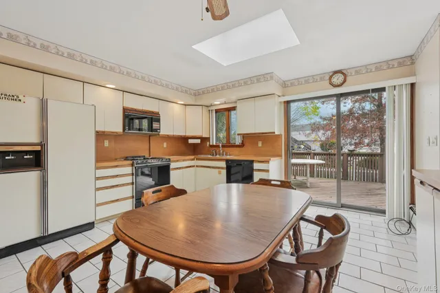 a view of a dining room with furniture and window