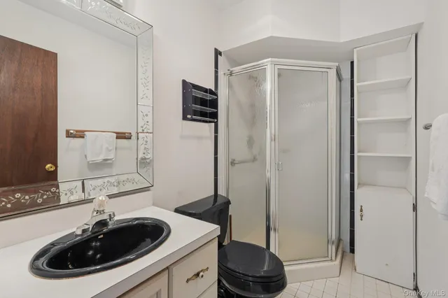 an empty room with chandelier fan and windows