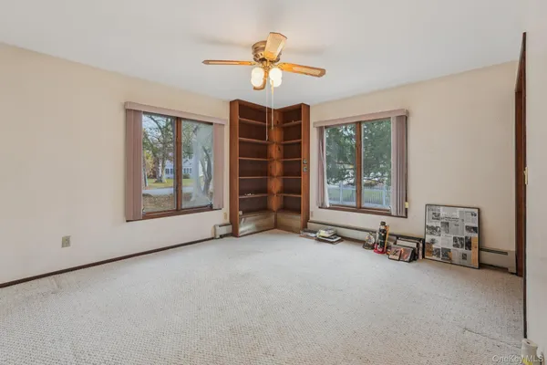 an empty room with windows and closet