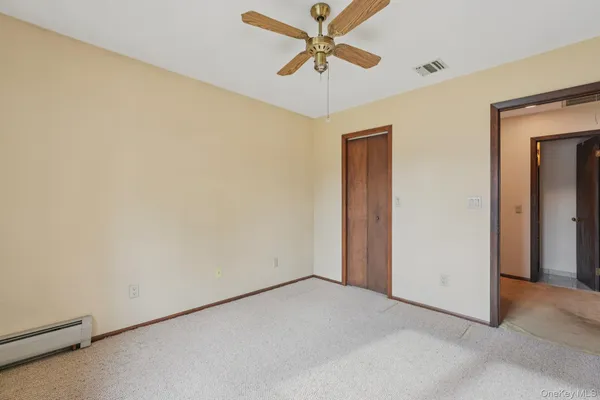 a view of a hallway with a ceiling fan