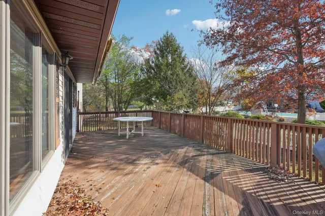 a backyard of a house with large trees and barbeque oven