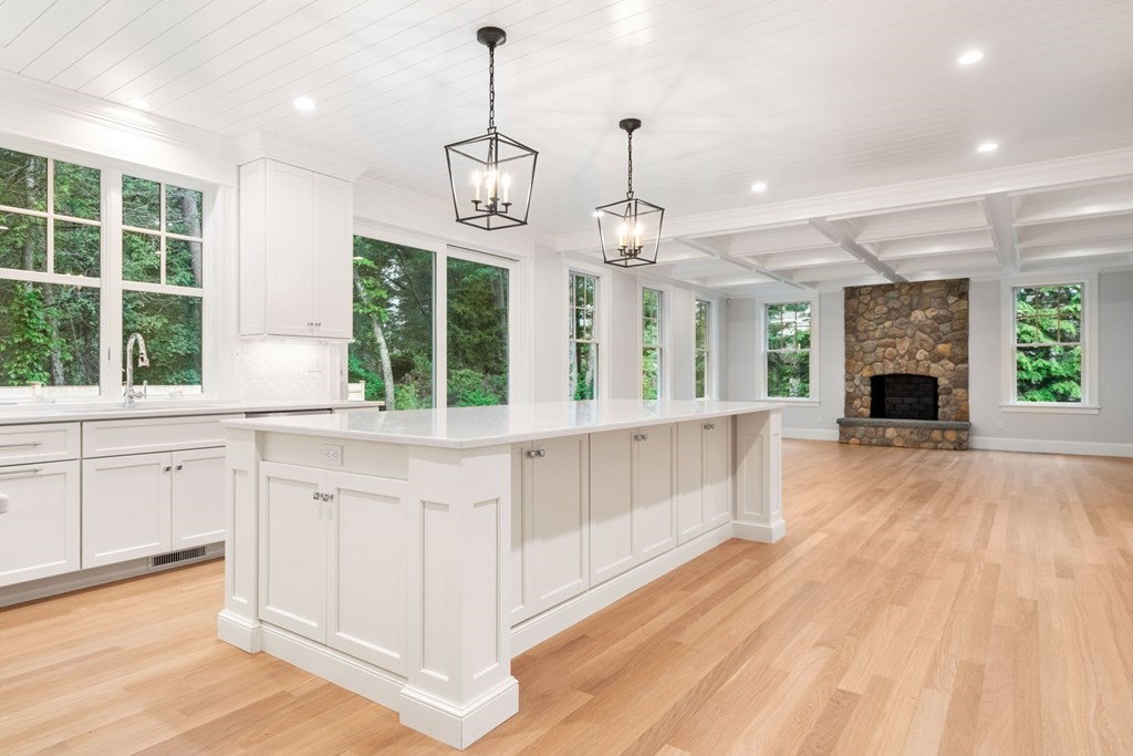 8 Hampshire Road Wellesley, MA 02481 - Photo 11 of 39 a large kitchen with kitchen island granite countertop wooden floor a large window and stainless steel appliances