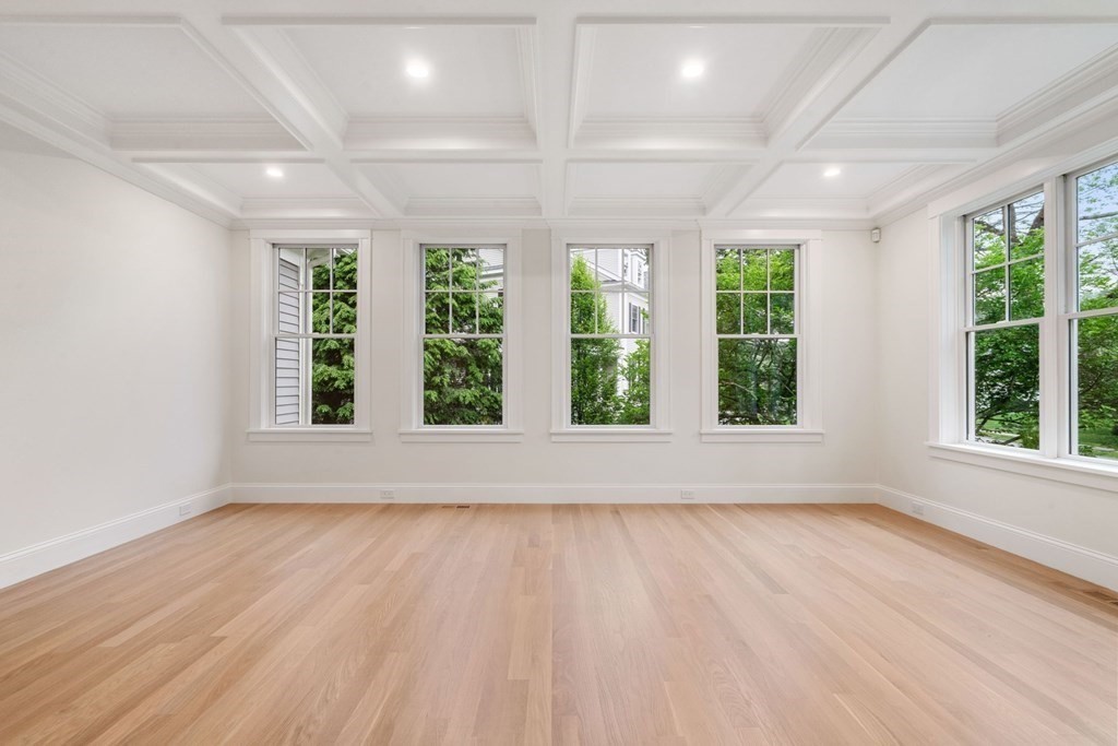 8 Hampshire Road Wellesley, MA 02481 - Photo 14 of 39 a view of an empty room with wooden floor and a window