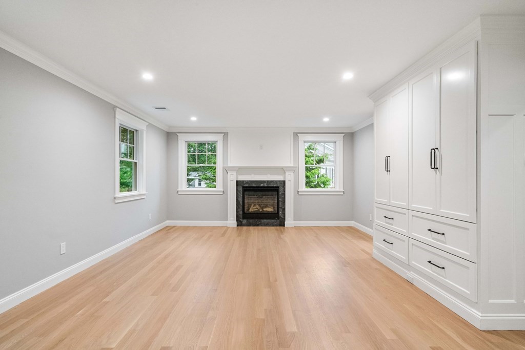 8 Hampshire Road Wellesley, MA 02481 - Photo 18 of 39 a view of an empty room with a window and fireplace