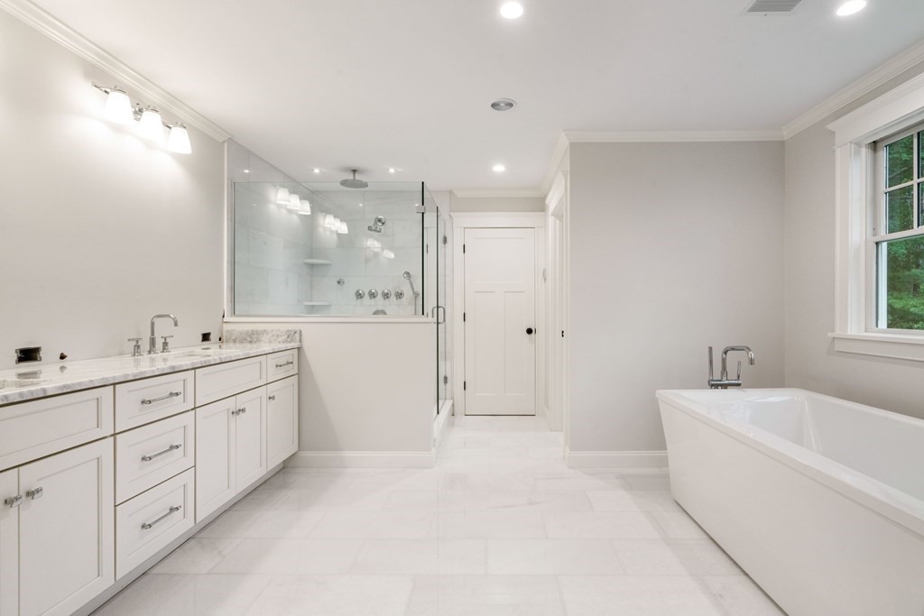 8 Hampshire Road Wellesley, MA 02481 - Photo 20 of 39 a large bathroom with a double vanity sink a mirror and a bathtub