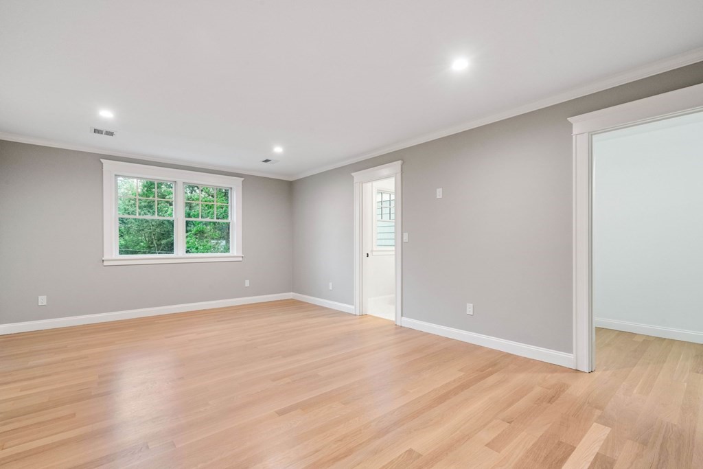 8 Hampshire Road Wellesley, MA 02481 - Photo 22 of 39 a view of an empty room with wooden floor and a window