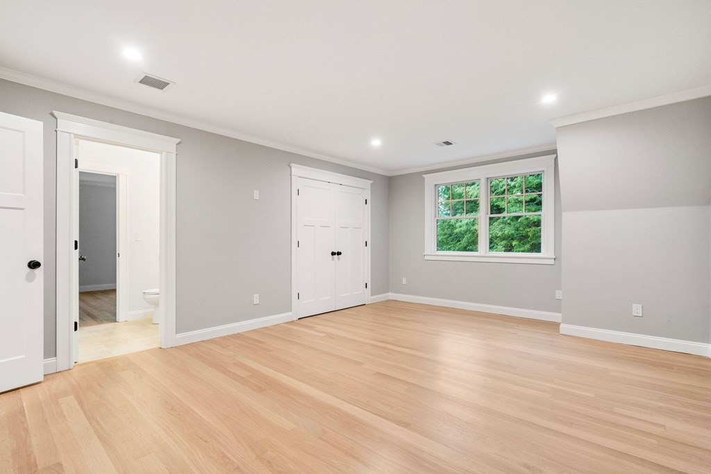8 Hampshire Road Wellesley, MA 02481 - Photo 23 of 39 a view of an empty room with wooden floor and a window