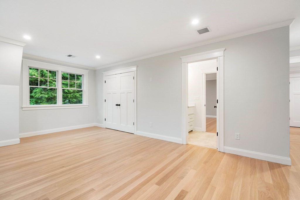 8 Hampshire Road Wellesley, MA 02481 - Photo 24 of 39 a view of an empty room with wooden floor and a window