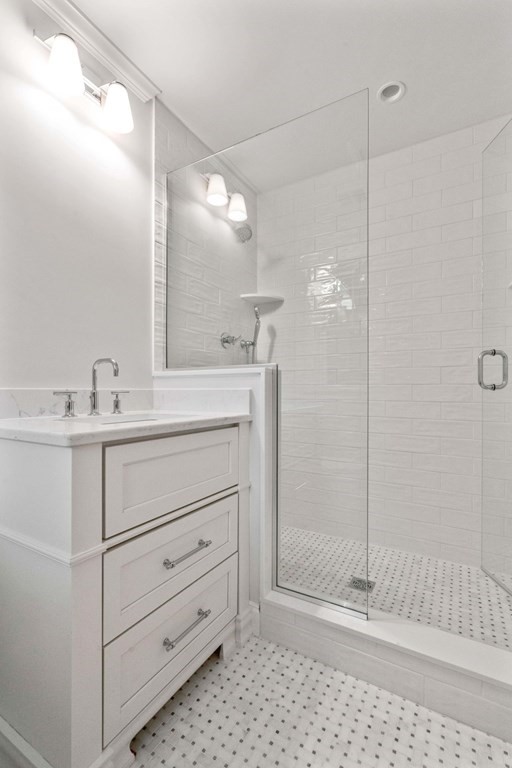 8 Hampshire Road Wellesley, MA 02481 - Photo 25 of 39 a bathroom with a shower sink and mirror