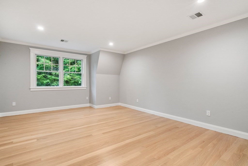 8 Hampshire Road Wellesley, MA 02481 - Photo 26 of 39 an empty room with wooden floor and windows