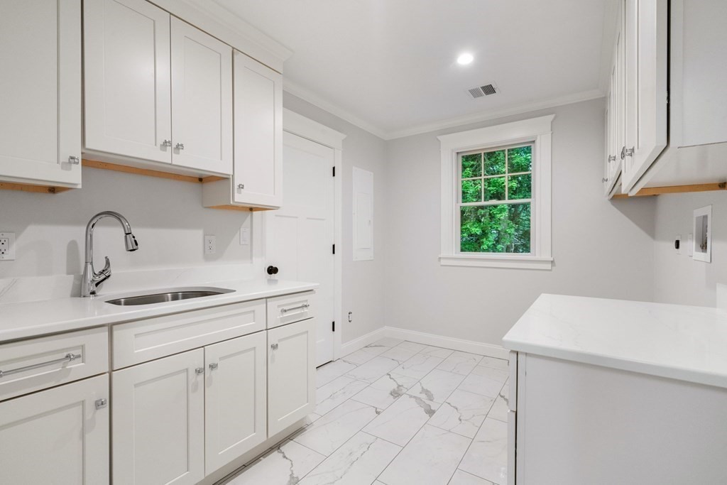 8 Hampshire Road Wellesley, MA 02481 - Photo 28 of 39 a kitchen with a sink and cabinets