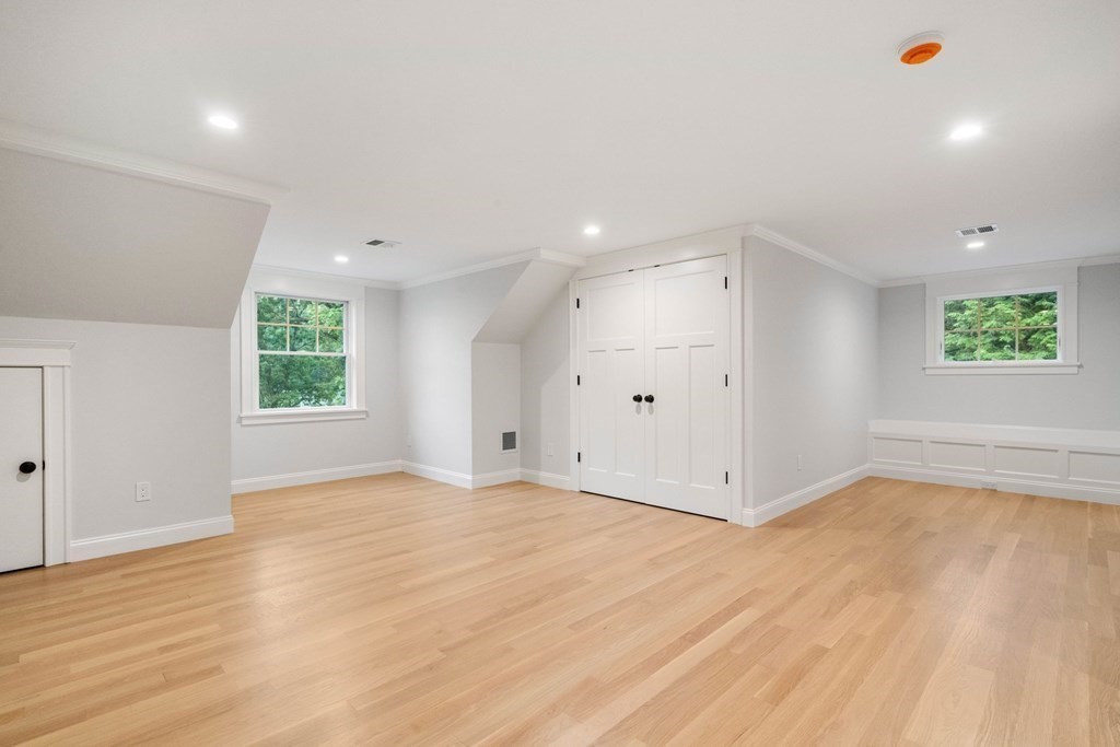 8 Hampshire Road Wellesley, MA 02481 - Photo 30 of 39 a view of an empty room with wooden floor and window