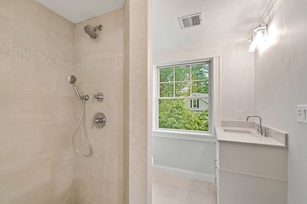 8 Hampshire Road Wellesley, MA 02481 - Photo 32 of 39 a bathroom with a granite countertop sink a shower and a window