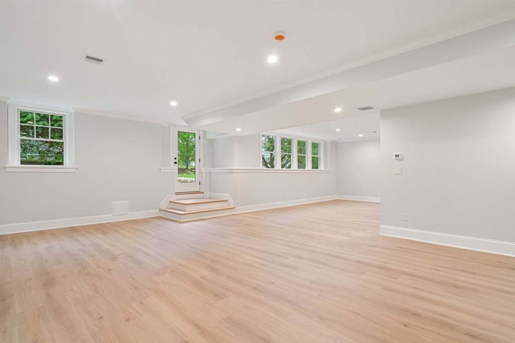 8 Hampshire Road Wellesley, MA 02481 - Photo 35 of 39 an empty room with wooden floor and windows