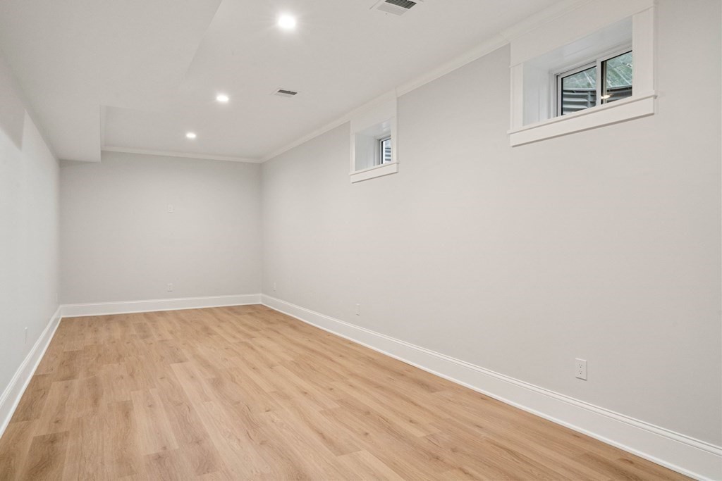 8 Hampshire Road Wellesley, MA 02481 - Photo 36 of 39 a view of an empty room with wooden floor and a window