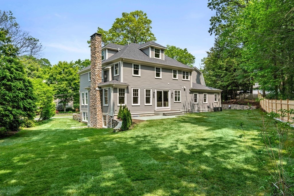 8 Hampshire Road Wellesley, MA 02481 - Photo 6 of 39 a front view of a house with a yard table and chairs