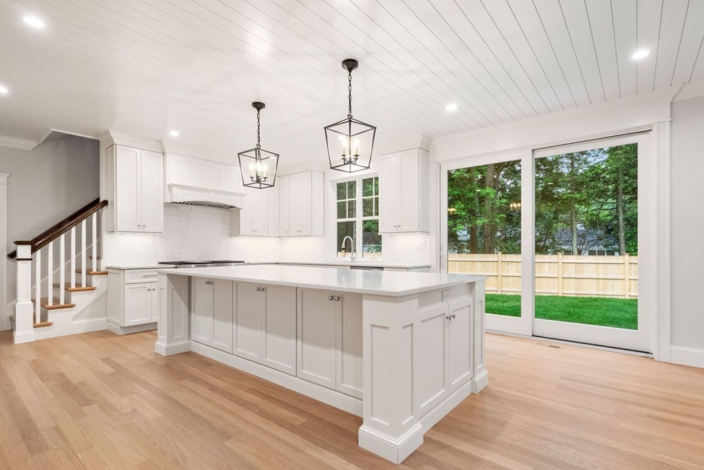 8 Hampshire Road Wellesley, MA 02481 - Photo 8 of 39 a kitchen with kitchen island granite countertop a stove and a wooden floors