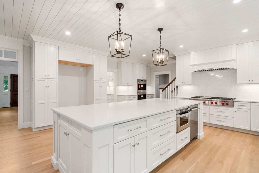 8 Hampshire Road Wellesley, MA 02481 - Photo 10 of 39 a large kitchen with kitchen island a stove a sink a center island and wooden floor
