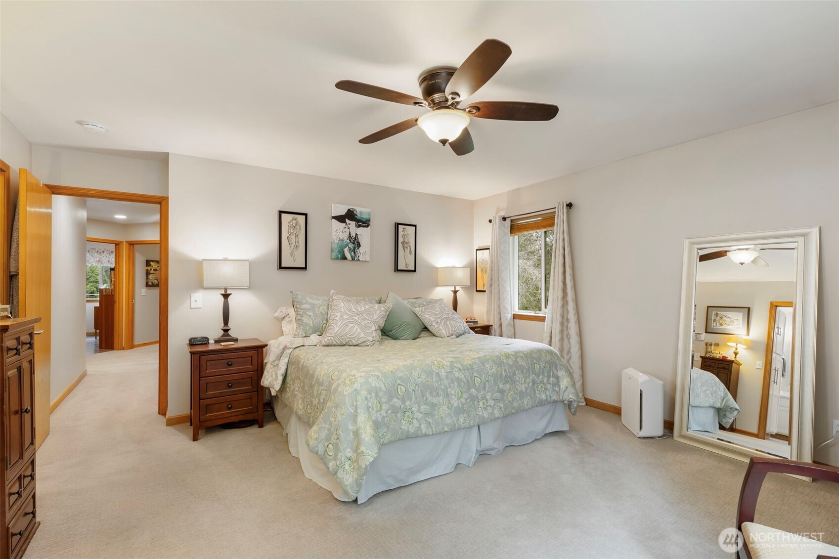 9240 Priddy Vista Road Northwest Seabeck, WA 98380 - Photo 15 of 40 a bedroom with a bed and ceiling fan