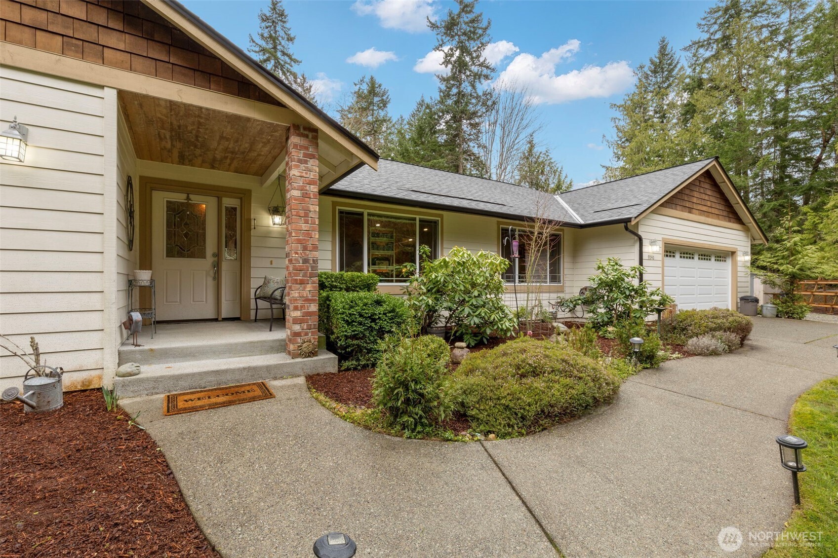 9240 Priddy Vista Road Northwest Seabeck, WA 98380 - Photo 2 of 40 a front view of a house with a yard