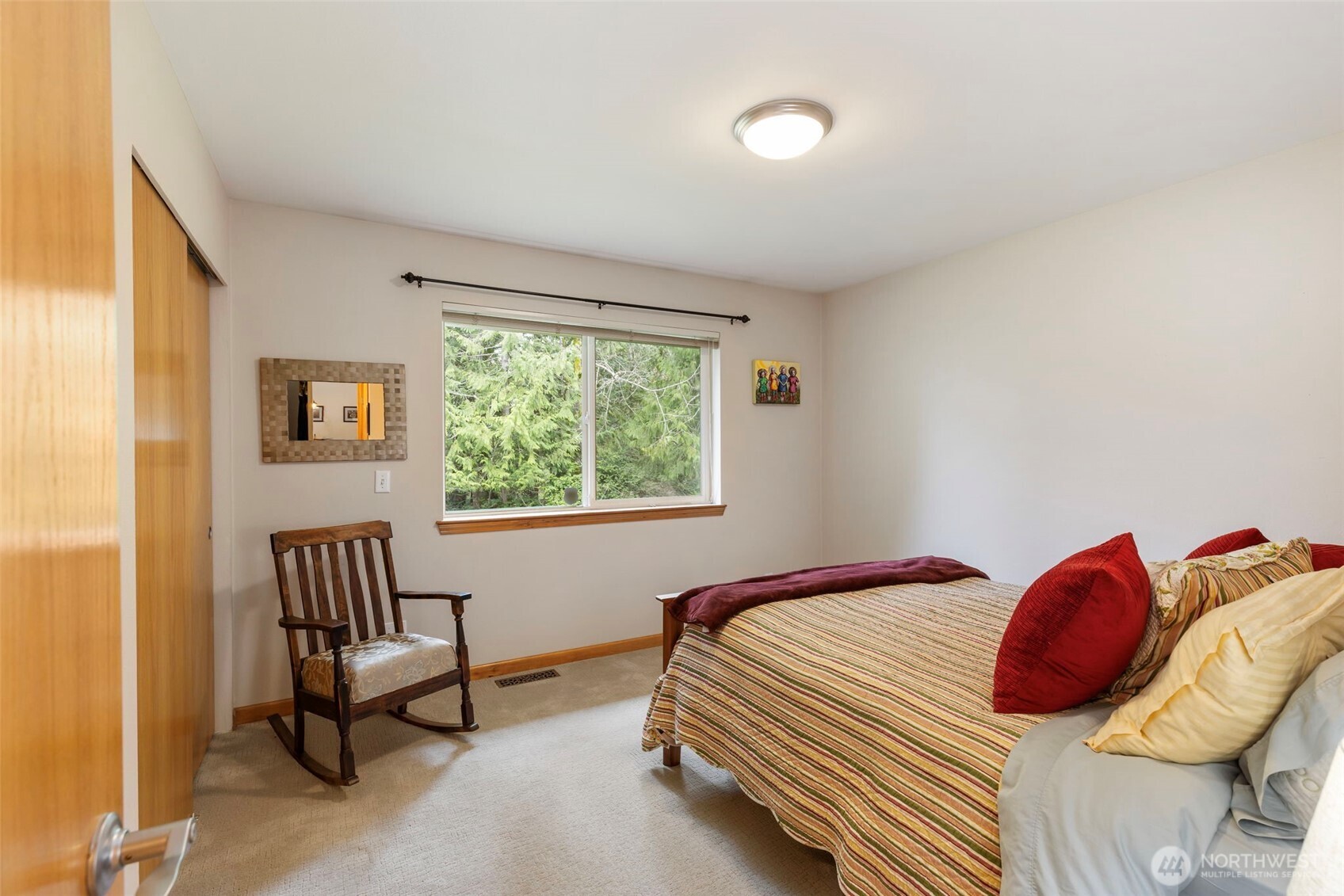 9240 Priddy Vista Road Northwest Seabeck, WA 98380 - Photo 21 of 40 a bedroom with a bed and a window